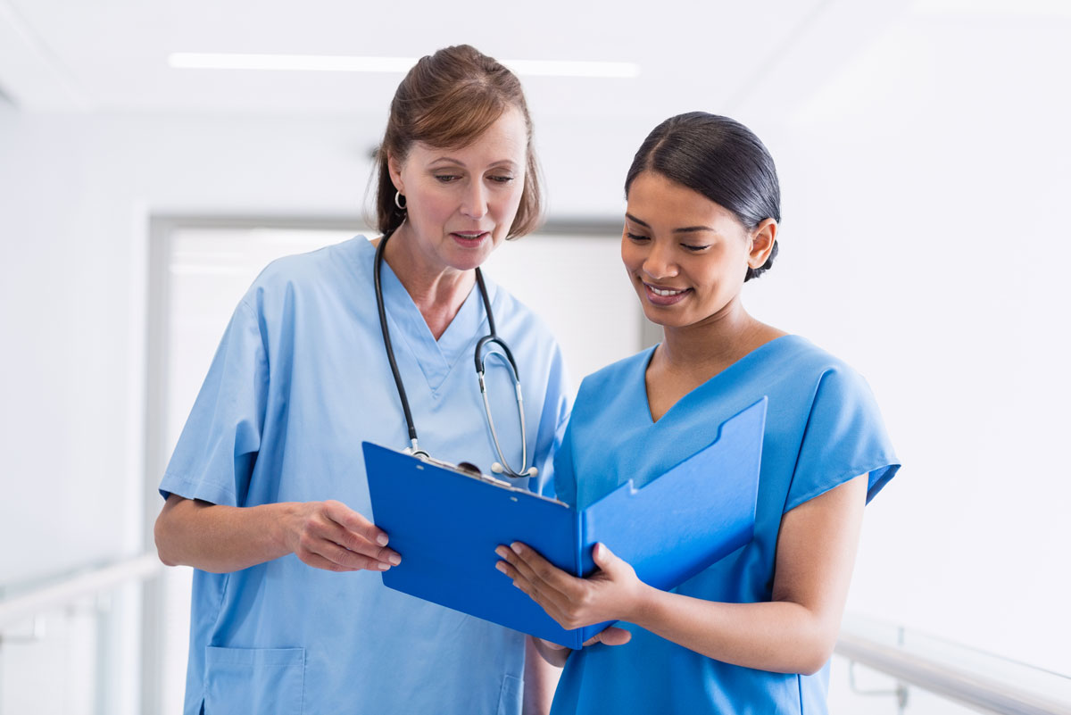Two nurses sharing notes