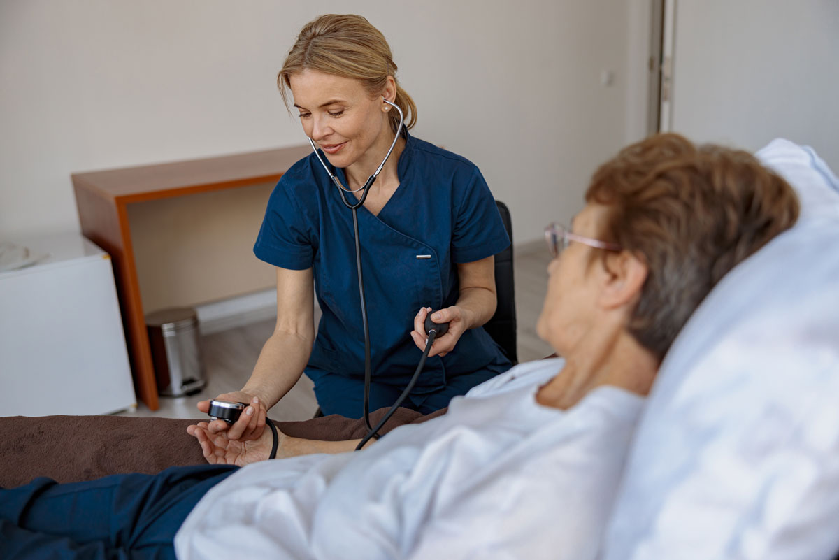 nurse checking blood pressure